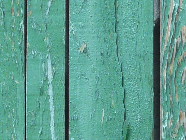 Rustic planks in varying widths and turquoise tint. Thin wires run across the planked surface.